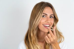 woman putting in clear aligners