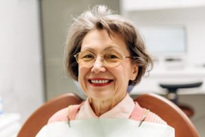 Elderly,Woman,With,Glasses,Smiling,While,Seated